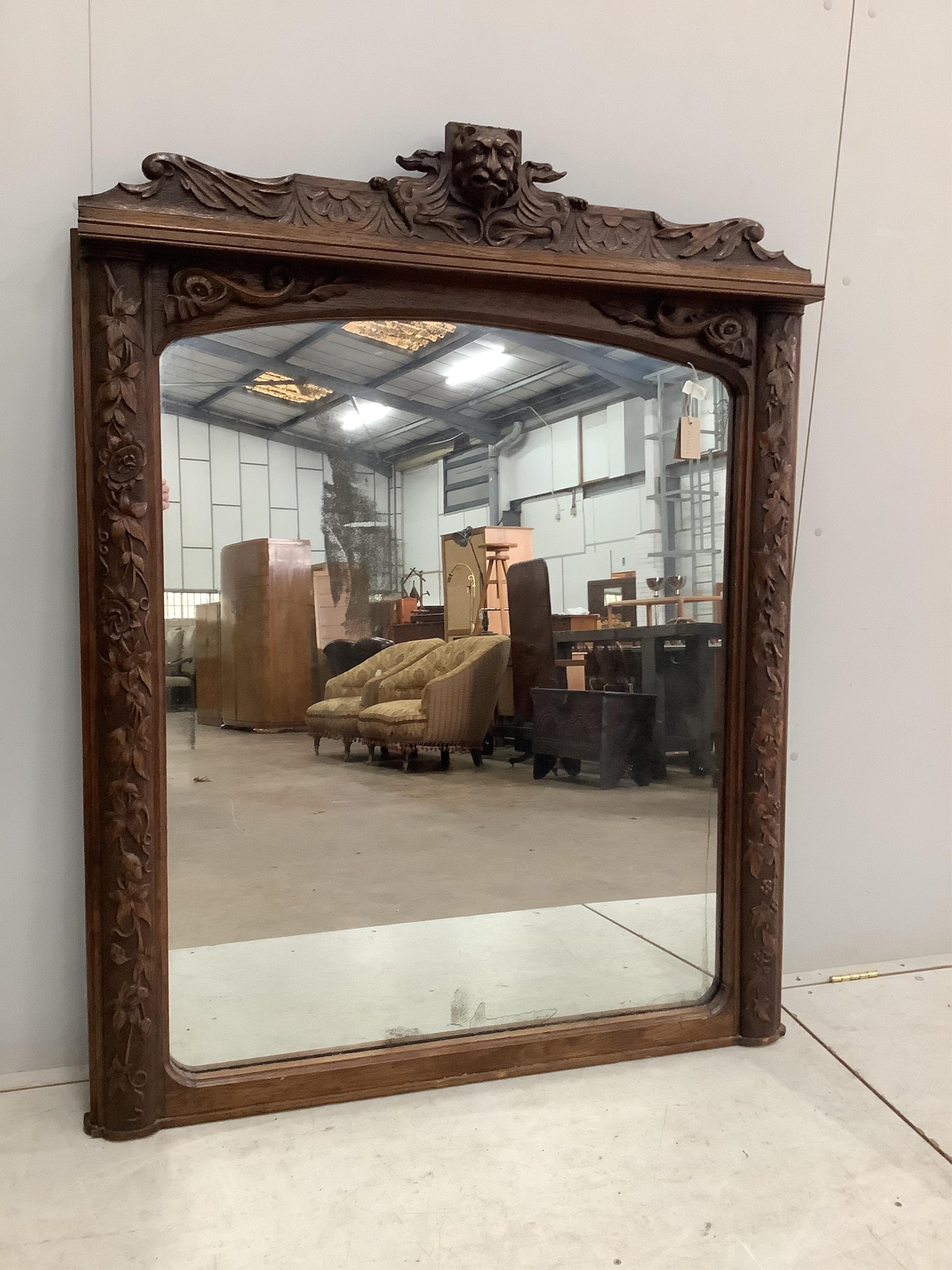 A Victorian carved oak overmantel mirror, width 120cm, height 152cm. Condition - fair